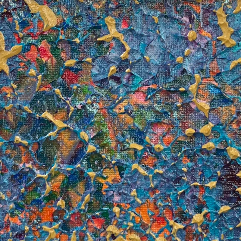 A close-up of abstract artwork in blue and gold.
