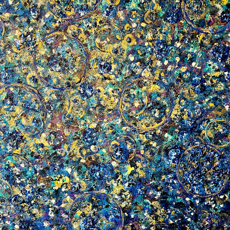 A close-up of abstract artwork with gold circles.