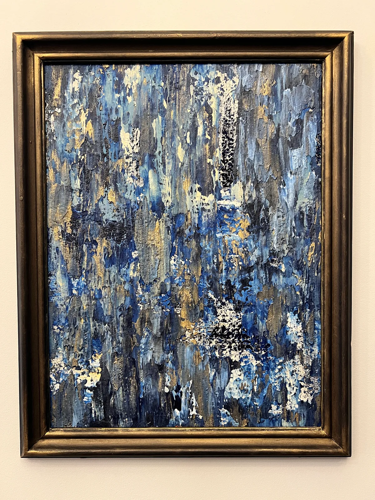 Let the Storm Rage, a blue and gold abstract painting in a dark gold frame.