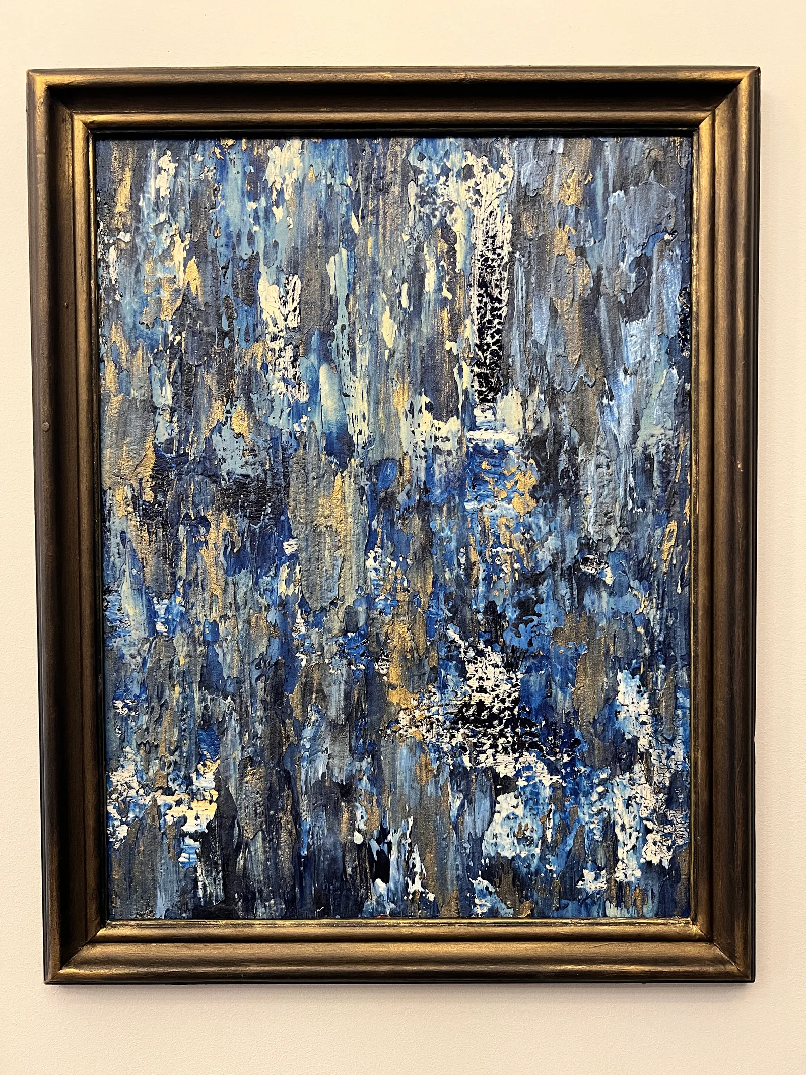 Let the Storm Rage, a blue and gold abstract painting in a dark gold frame.
