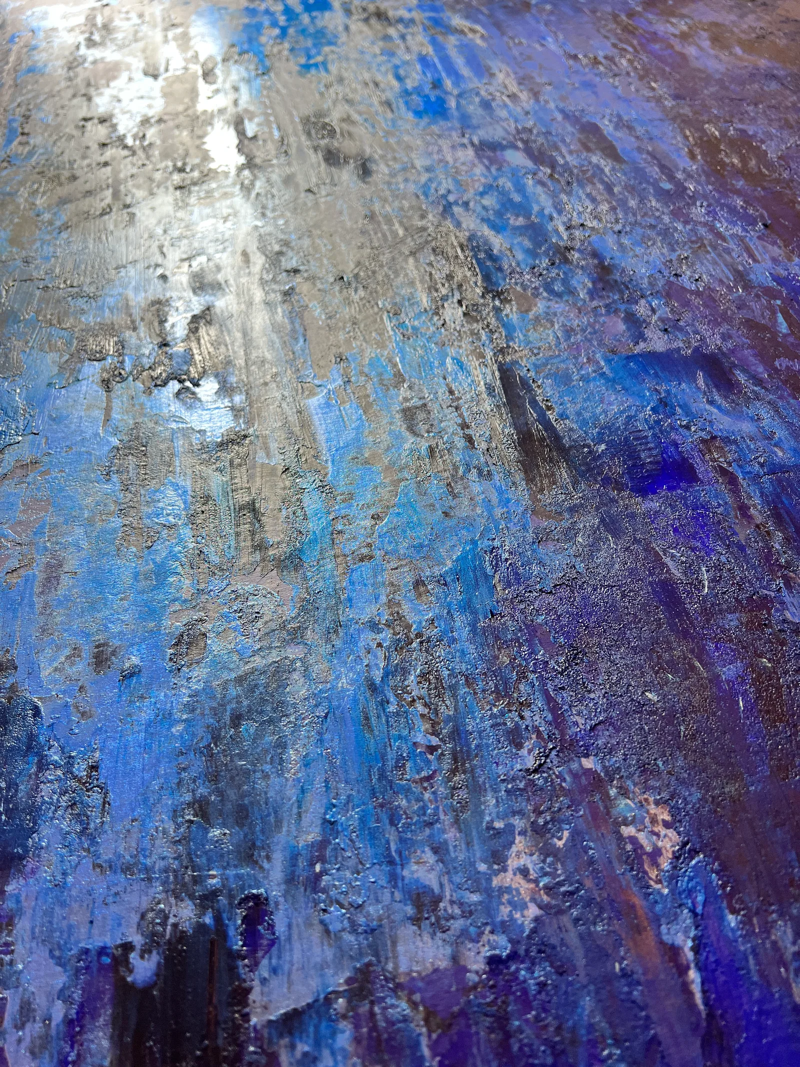 Angled close-up of the blue and silver paint textures in Undercurrent.