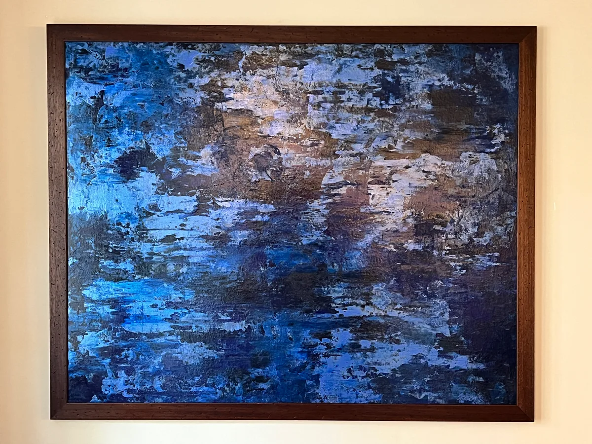 Undercurrent, a blue, violet and silver abstract painting in a brown frame.